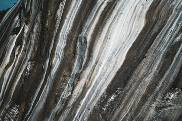 Steep rock formations of Ilha Cagarra, Cagarras Islands, Rio de Janeiro, Brazil. Visible white streaks are caused by seabird excrement, creating a unique natural pattern