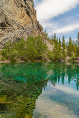 Breathtaking views of the upper and lower Grassi Lakes with brilliant turquoise and aqua waters set in a serene wilderness outside the town of Canmore near Kananaskis during the summer season.