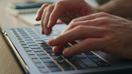 Unrecognizable writer typing keyboard laptop creating article at office close up