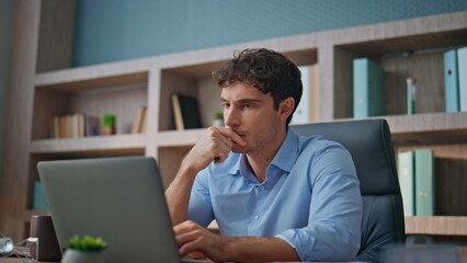 Focused professional thinking problem in office closeup. Young businessman read