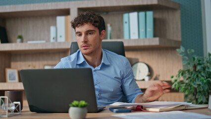 Fototapeta premium Company executive reading bad news in office. Angry man looking computer error