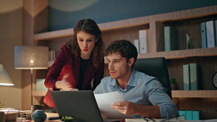 Woman boss teaching trainee man at office looking laptop. Manager rejoicing work