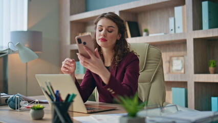 Frustrated businesswoman reading sms at work. Shocked manager receive bad news