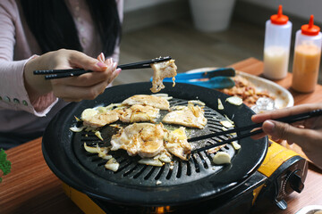 Hands Holding Chicken Steak Using Chopstick In Asian Barbeque Food Style