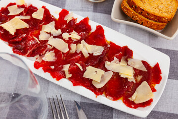 Veal carpaccio, Italian appetizer made with thin slices of raw meat served with parmesan cheese