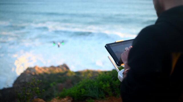 Drone, remote control and man with technology at beach filming nature, water or landscape. Videography, photographer and test flight for aerial photography recording of ocean at sunset or sunrise