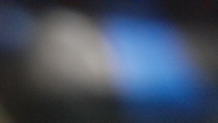 The black background is decorated with blue and white gradations with a defocused grainy noise blur effect