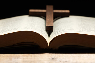 Bible and cross on table, closeup. Religion of Christianity