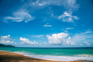 Summer tropical beach white sand blue sea summertime on sunny day. Sea coast beach scenery foamy wave on the beach waves of blue sea tropical ocean sand. Travel holidays vacation seaside turquoise