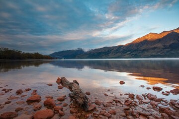 Sunrise at Lake Wakatipu, New Zealand. Sun shining on mountain peaks
