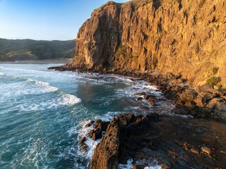 Rocky coastline and ocean waves at Anawhata, Piha, Auckland, New Zealand.
