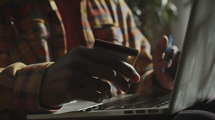 A man is holding a credit card in front of a laptop Concept of financial responsibility and the importance of managing ones finances Homework : Generative AI