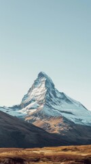 a solitary mountain peak with a bright blue sky background, a very realistic view, Generative ai