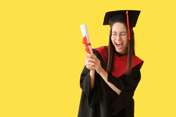 Cheerful female graduate diploma on yellow background