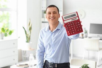 Male accountant with calculator in office