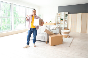 Young man with stretch wrap and cardboard box at home