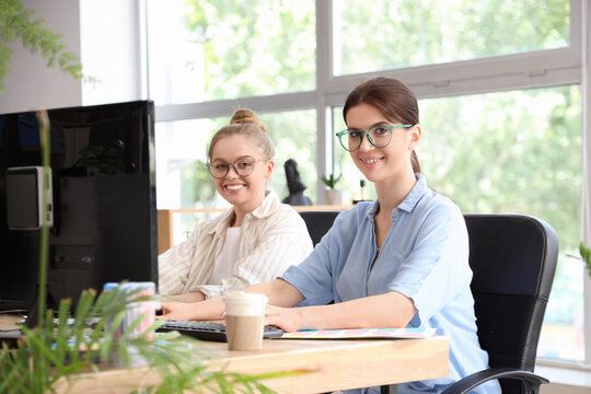 Female programmers working at table in office