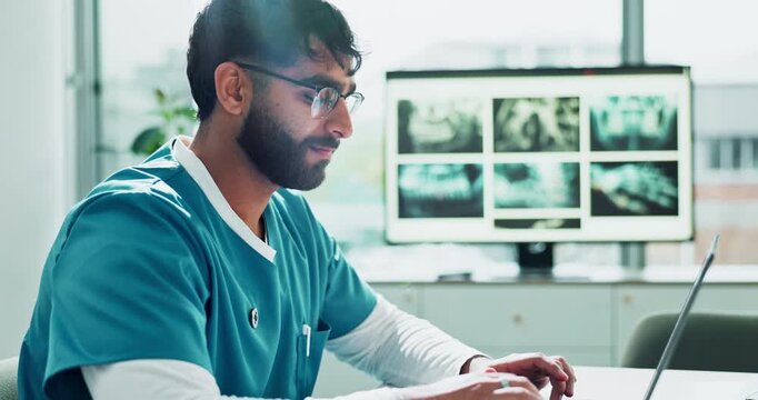 Man, medical intern with laptop in hospital, healthcare employee and typing online or research. Email, virtual patient and xray examination or diagnosis results, internet and communication in office