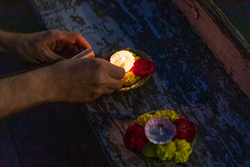India, Uttar Pradesh, Varanasi, Ganges River. People prepare small candles to float out on the river.