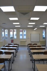 Empty Classroom with Desks, Chairs, and a Whiteboard