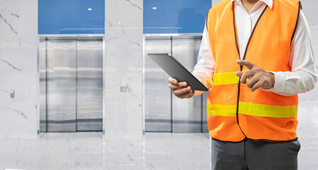 Technician or engineer check on elevator or passenger lift © phonlamaiphoto