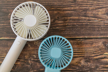 Portable handheld fans for keeping cool in summer