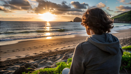 Fototapeta premium a tourist man looking at the sunset from the sea with a sandy beach