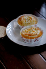 Sweet cake on a white plate and wooden table for your design elements