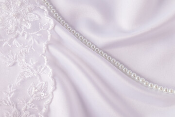 Delicate lace wedding embroidered tulle on white satin fabric with waves on the left side. border. postcard. cover. album. wedding layout.