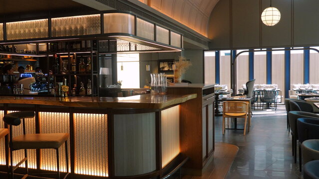 Modern interior of cozy bar with stylish furniture and warm lighting, ideal for relaxing evening or social gatherings in upscale environment. Hospitality and Leisure.