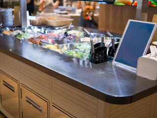 Empty food menu on dark background next to food in refrigerators, ready to be filled with delicious options Food menu awaits creative dishes and enticing descriptions Food menu stands out in contrast