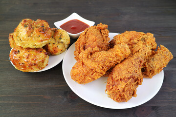 Plate of Delectable Fried Chickens with Aromatic Herb Biscuits Served on Wooden Table