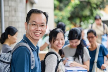 Obraz premium Portrait of an Asian philanthropist with volunteers at a donation drive, Generative AI