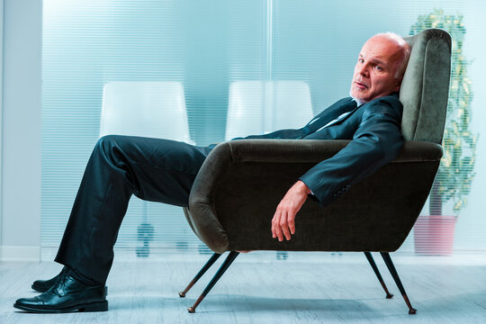 Businessman slouching, terrified of AI replacing jobs