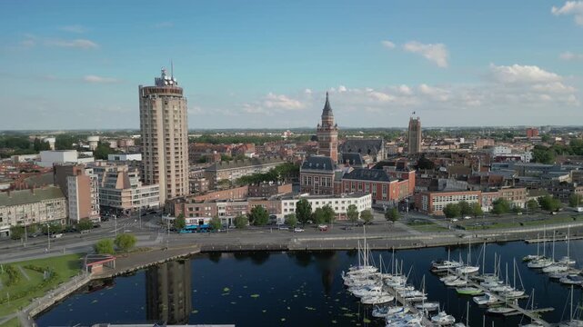 The drone aerial footage of Marina Port du Commerce and the tower of the townhall, Dunkirk, France. Dunkirk is a commune in the department of Nord in northern France.