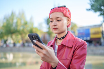 Traveler girl using mobile phone on street in city Fashion gen z asian woman .Technology connection...