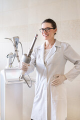 female doctor holds in her hands a carbon dioxide laser with a phallic attachment for vaginal...