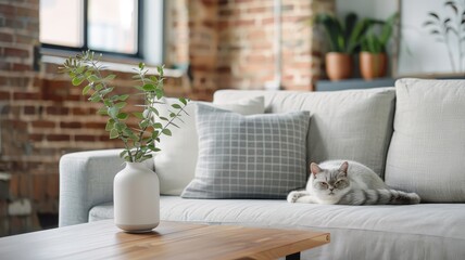 Fototapeta premium British Shorthair cat in a stylish urban loft with exposed brick walls, contemporary furnishings, and a cozy atmosphere.