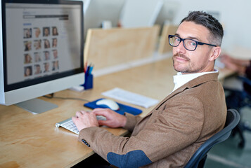 Business man, portrait and computer screen for website portfolio, project and photography homepage production. Mature person, creative director and editor on technology for model picture management