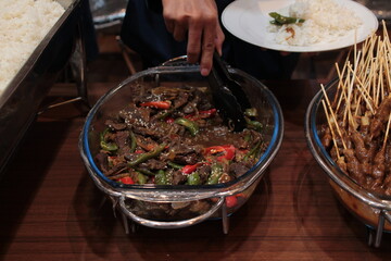 Delicious and tasty beef rendang served in a glass tray