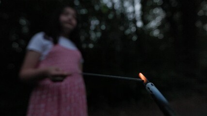  SLO MO Tracking a green sparkler held by an adolescent Filipino-American girl on the Fourth of July. Captured at 120 frames per second.