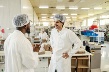 Food factory manager explaining to his new employee food making process at food factory