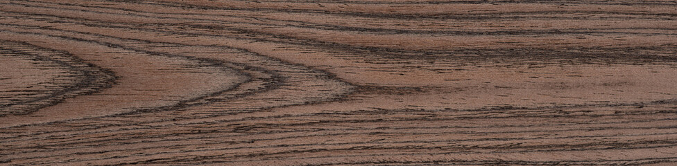 Flowing coppery swirls meander across this walnut veneer, evoking an organic symphony of color and texture