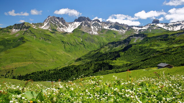The valley of Roselend, Beaufort, Beaufortain, Savoie, France, surrounded by mountain pastures and mountains (2 summits: pointe de Presset and Pierra Menta on the right)