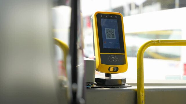 Close up of yellow card reader with qr code near the bus driver for Istanbulkart in public city transport. Modern transport infrastructure of Istanbul for residents and tourists