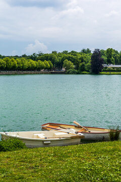 Serene Lake Scene with Rowboats and Lush Greenery at Chateau de Fontainebleau