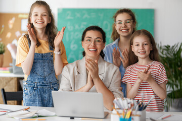Happy kids and teacher at school