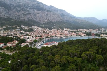 Makarska, Croatia. Coastal town, sea and mountains, Biokovo park. Aerial photography from a drone. Croatian town on the Adriatic Sea. Makarska Riviera