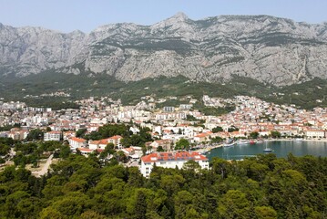 Makarska, Croatia. Coastal town, sea and mountains, Biokovo park. Aerial photography from a drone. Croatian town on the Adriatic Sea. Makarska Riviera