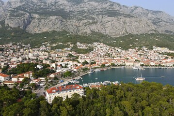 Fototapeta premium Makarska, Croatia. Coastal town, sea and mountains, Biokovo park. Aerial photography from a drone. Croatian town on the Adriatic Sea. Makarska Riviera